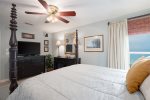 Beautiful master bedroom offers a queen bed, tv, and beach view.